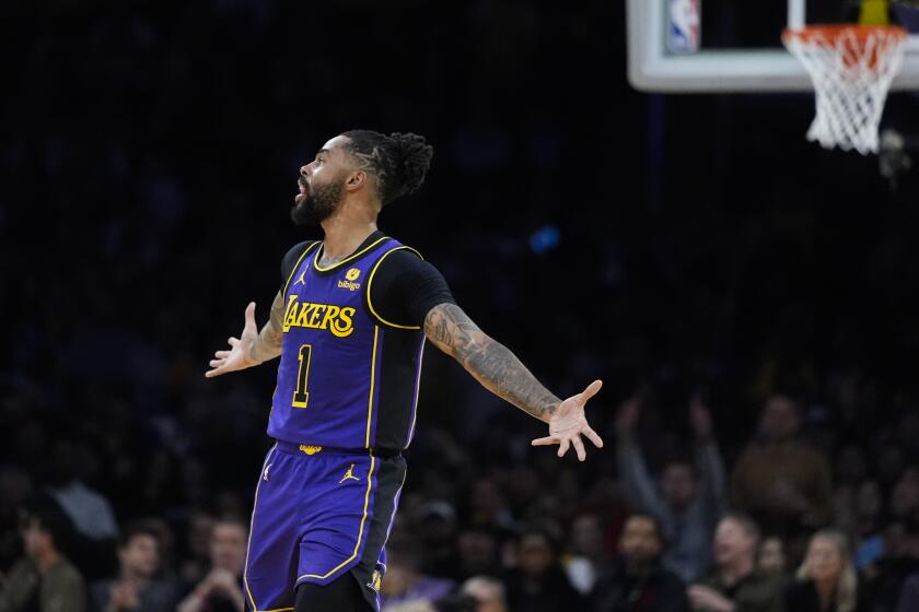 Lakers guard D'Angelo Russell celebrates after making a three-point shot against the Bucks on Friday at Crypto.com Arena.
