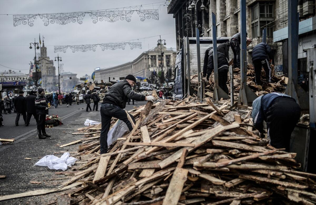 People collect wood at the camp in Kiev's Independence Square on Tuesday.