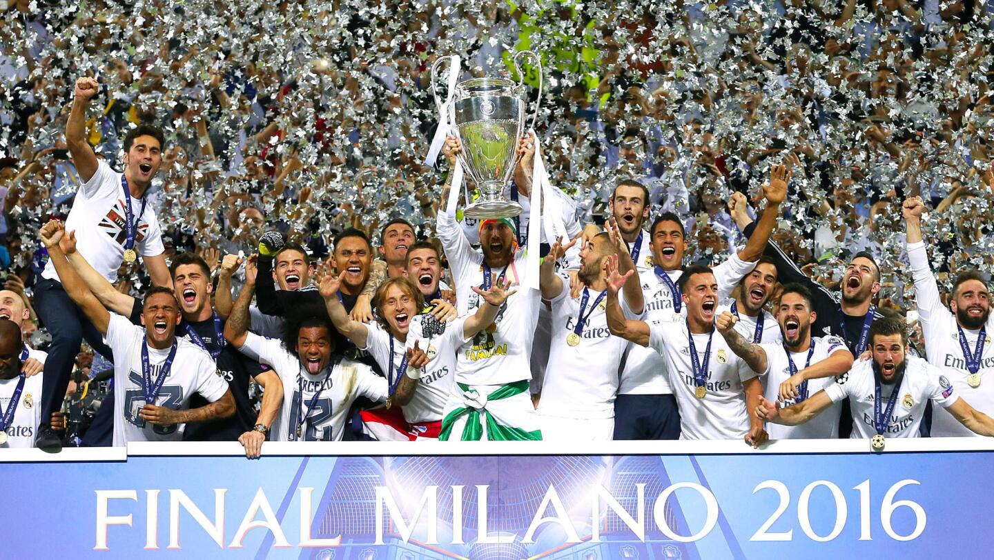 Los jugadores del Real Madrid celebran con el trofeo de la Liga de Campeones tras ganar en la tanda de penaltis al Atlético de Madrid en la final jugada en el estadio de San Siro, en Milán