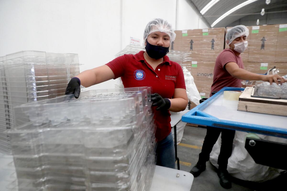 A factory worker at Innovet, a company that shifted to making plastic visors and other protective gear.