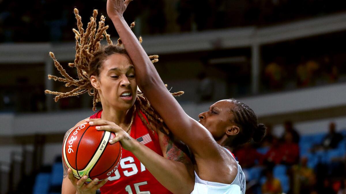 USA's Brittney Griner is covered by France's center Sandrine Gruda during second half action.