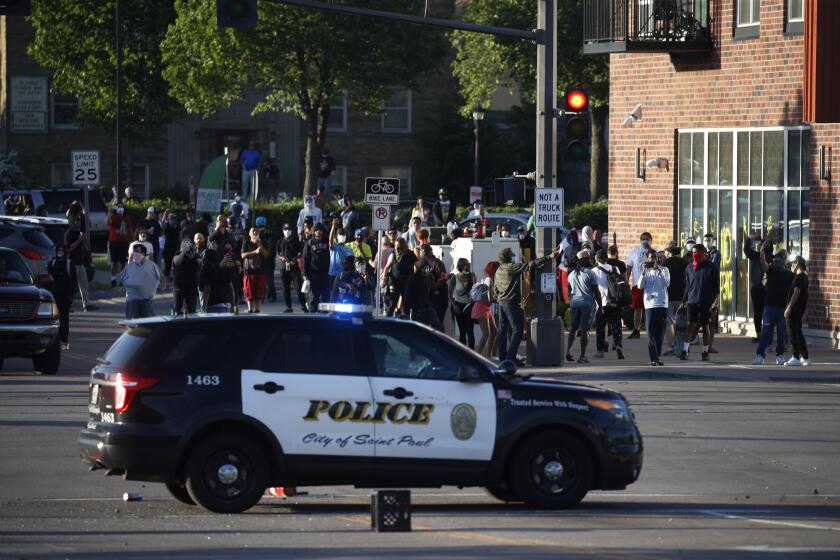 Protesters gather Thursday, May 28, 2020, in St. Paul, Minn. Minnesota Gov. Tim Walz called in the National Guard on Thursday as looting broke out in St. Paul and a wounded Minneapolis braced for more violence after rioting over the death of George Floyd, a handcuffed black man in police custody, reduced parts of one neighborhood to a smoking shambles. (AP Photo/John Minchillo)