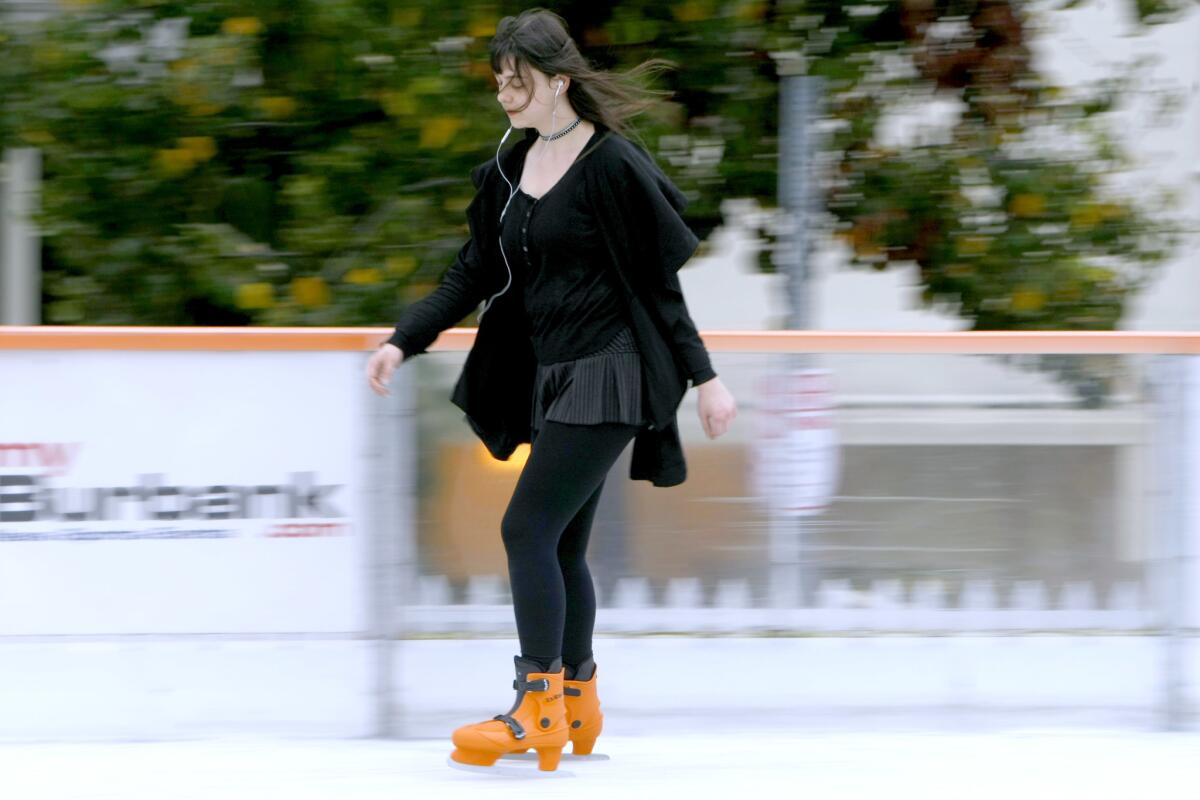 Faina Danielian, 19 of Burbank, ice skates while listening to music on opening day at the Rink8.