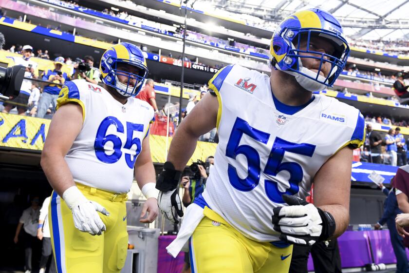 Inglewood, CA - February 13: Los Angeles Rams center Brian Allen (55) and center Coleman Shelton (65) makes his way onto the field for warm ups before Super Bowl LVI against the Cincinnati Bengals at SoFi Stadium on Sunday, Feb. 13, 2022 in Inglewood, CA. (Wally Skalij / Los Angeles Times)