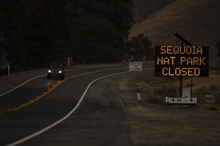 A digital sign by the roadside says Sequoia Nat Park Closed
