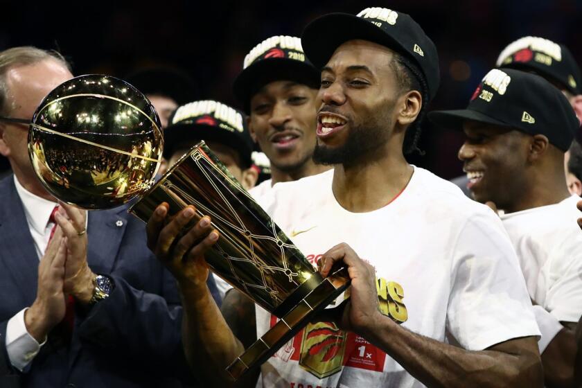 Kawhi Leonard of the Toronto Raptors celebrates with the Larry O'Brien Championship Trophy after his team defeated the Golden State Warriors to in Game 6 to close out the NBA Finals at ORACLE Arena in Oakland, Calif., on June 13, 2019. (Ezra Shaw/Getty Images/TNS) **FOR USE WITH THIS STORY ONLY** ** OUTS - ELSENT, FPG, TCN - OUTS **