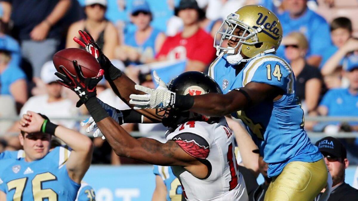 Utah cornerback Brian Allen intercepts a pass intended for UCLA receiver Theo Howard during a game on Oct. 22.