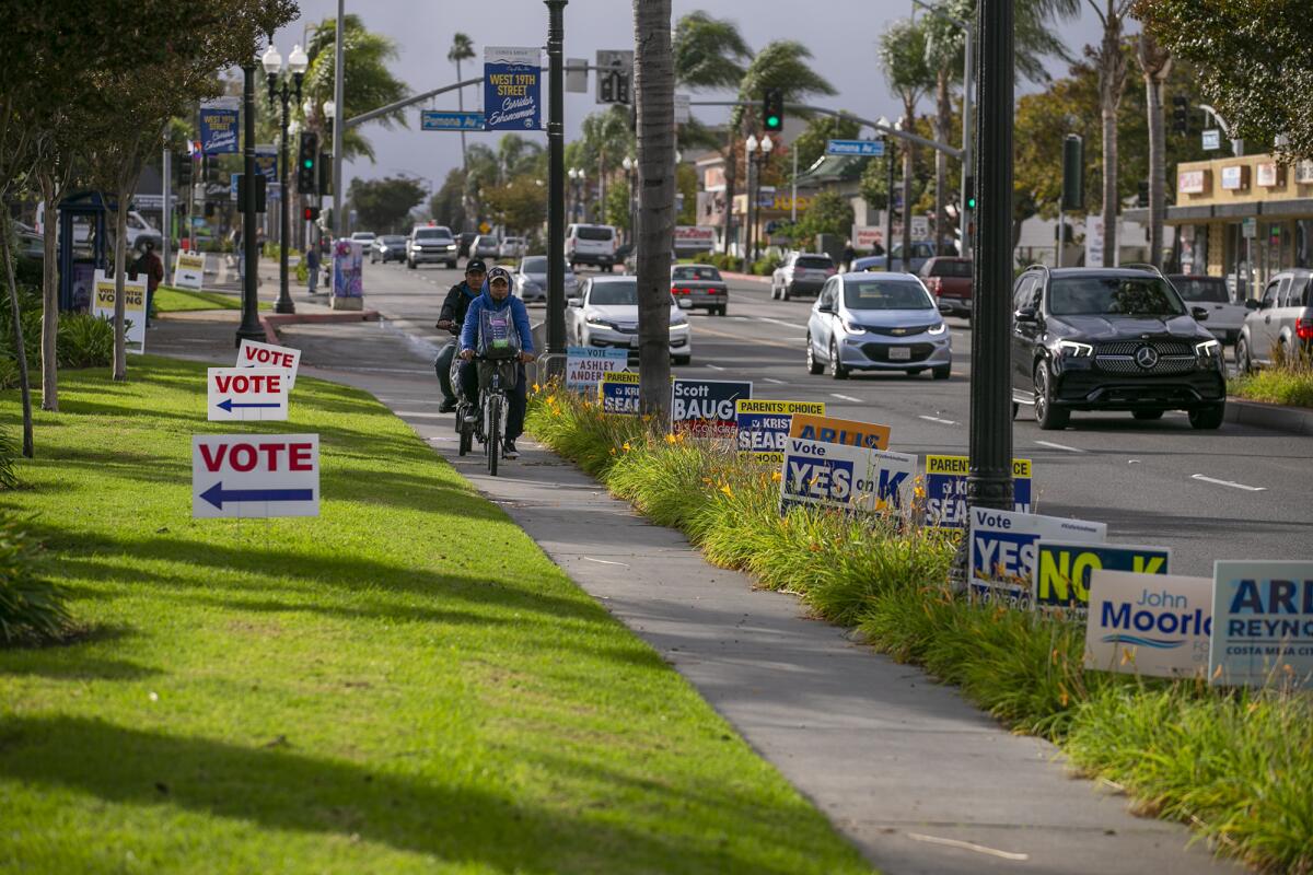 Signs line West 19th Street Tuesday in Costa Mesa, where voters elected a mayor and filled three contested council seats.