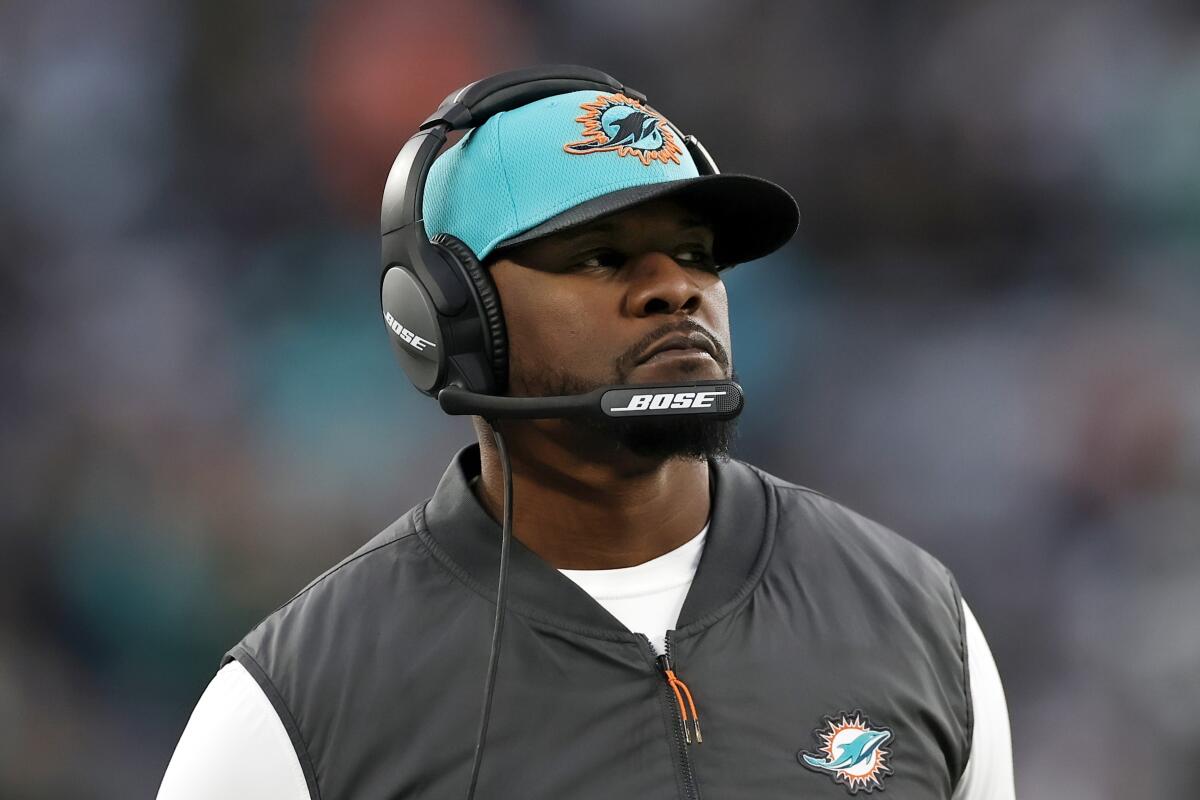 Miami Dolphins coach Brian Flores stands on the sideline during a game.