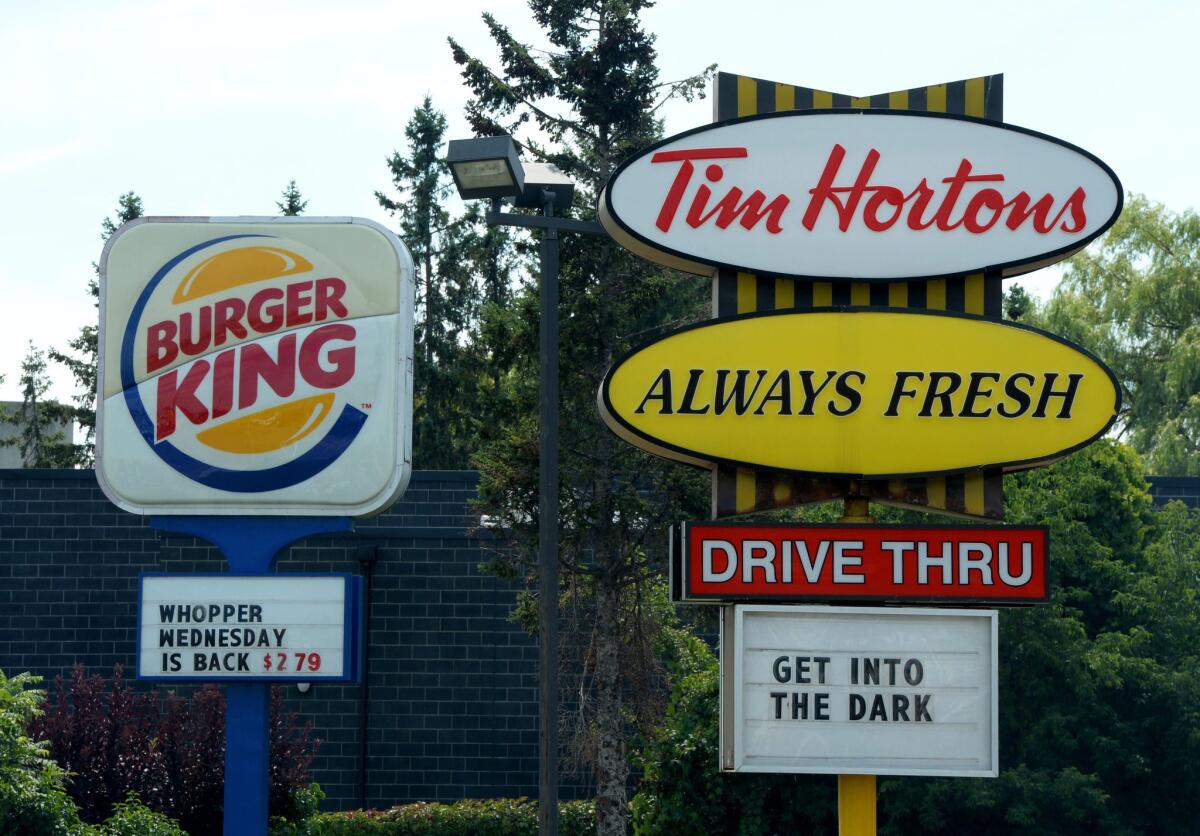 A Burger King and a Tim Hortons in Ottawa, Ontario. Burger King is in talks to buy Tim Hortons in hopes of creating a new, publicly traded company with its headquarters in Canada.