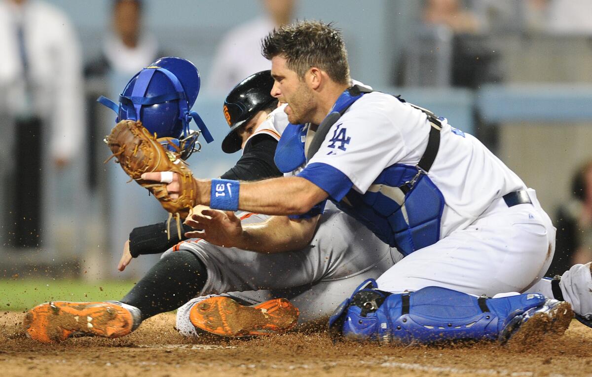 Dodgers catcher Drew Butera tags out San Francisco's Brandon Belt in September.