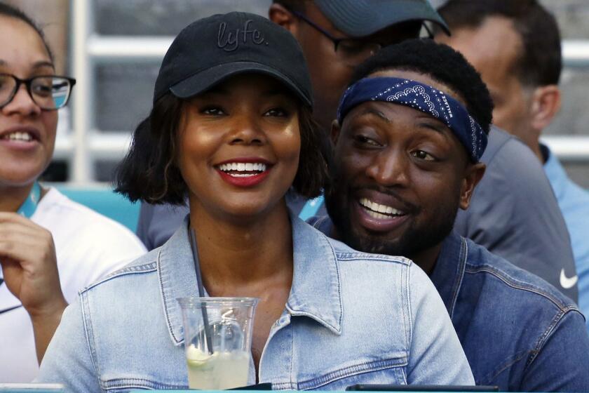 FILE - In this Sunday, Oct. 14, 2018 file photo, Miami Heat player Dwyane Wade and his wife Gabrielle Union-Wade acknowledge the cheers from the crowd during the second half of an NFL football game between the Miami Dolphins and the Chicago Bears in Miami Gardens, Fla. Miami Heat star Dwyane Wade and his wife Gabrielle Union-Wade have a baby. The couple on Thursday, Nov. 8, 2018 announced theyve welcomed a baby girl into the world. (AP Photo/Joel Auerbach, File)