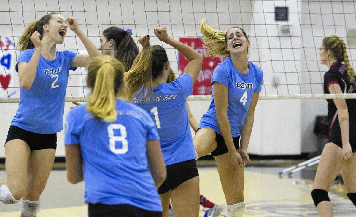 Corona del Mar High players celebrate a point in the second set against Beckman.