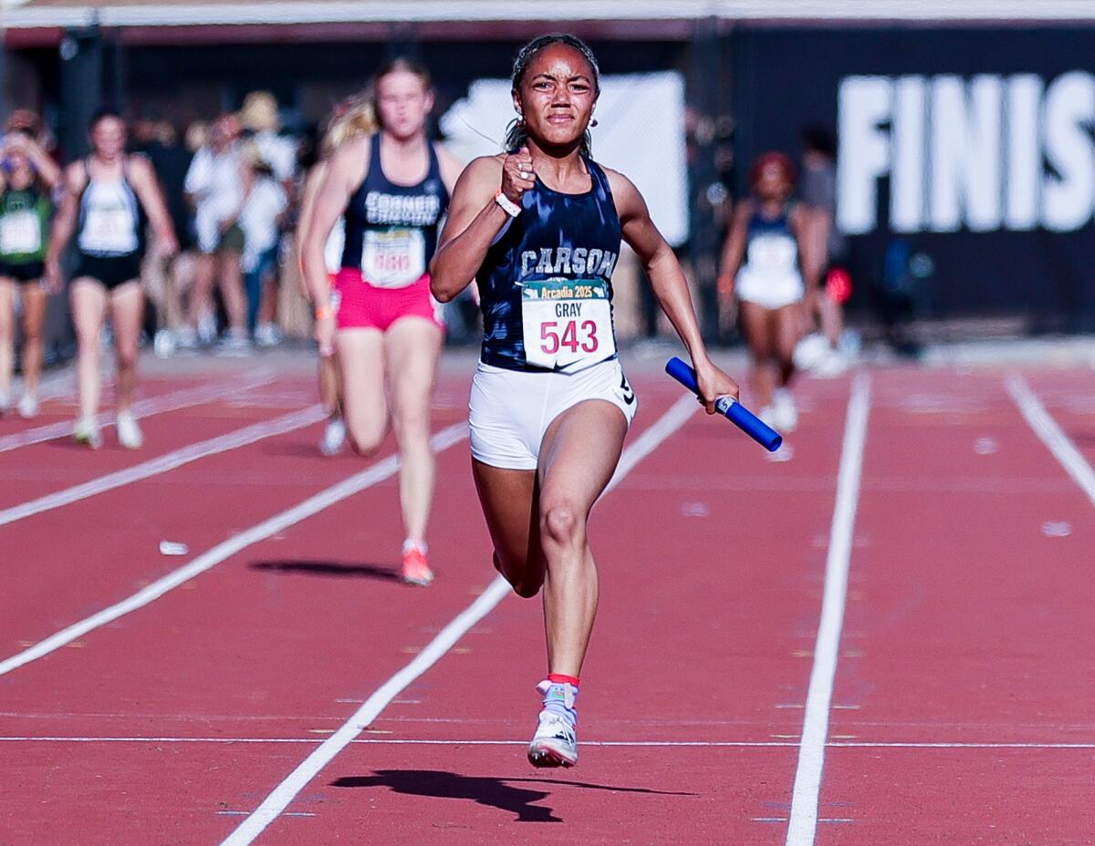 Christina Gray of Carson High sprints to the finish of the 4x100 relay with baton in hand.