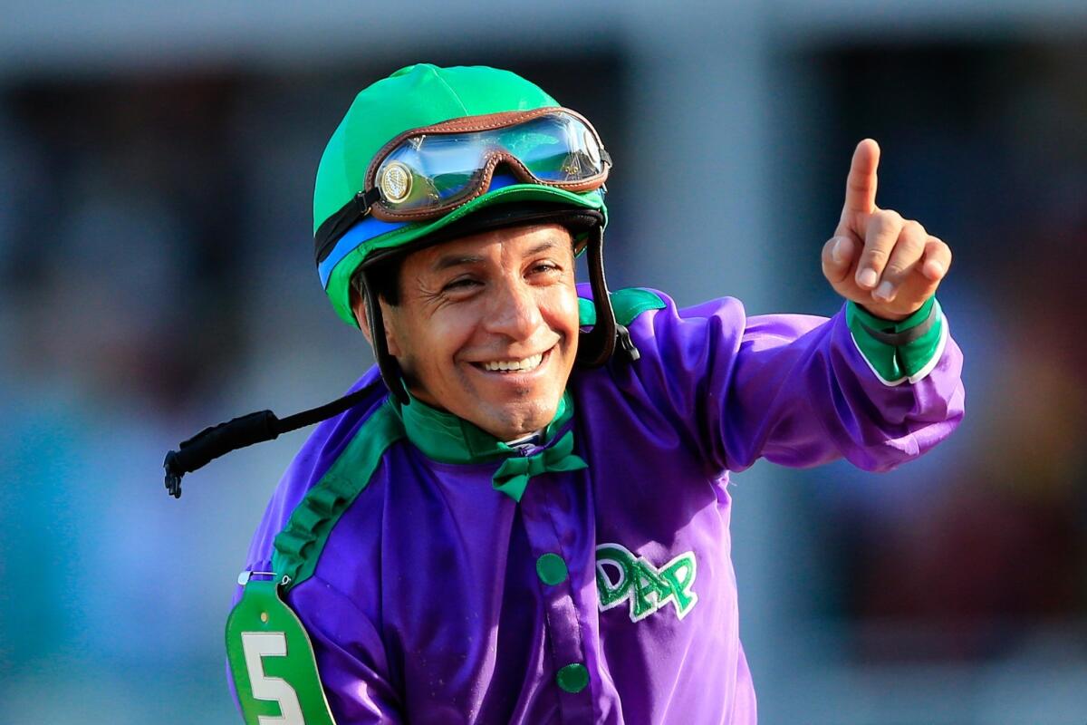 Jockey Victor Espinoza, who last won a Triple Crown race in 2002 in the Preakness Stakes, is all smiles after guiding California Chrome to the win Saturday in the 140th Kentucky Derby.