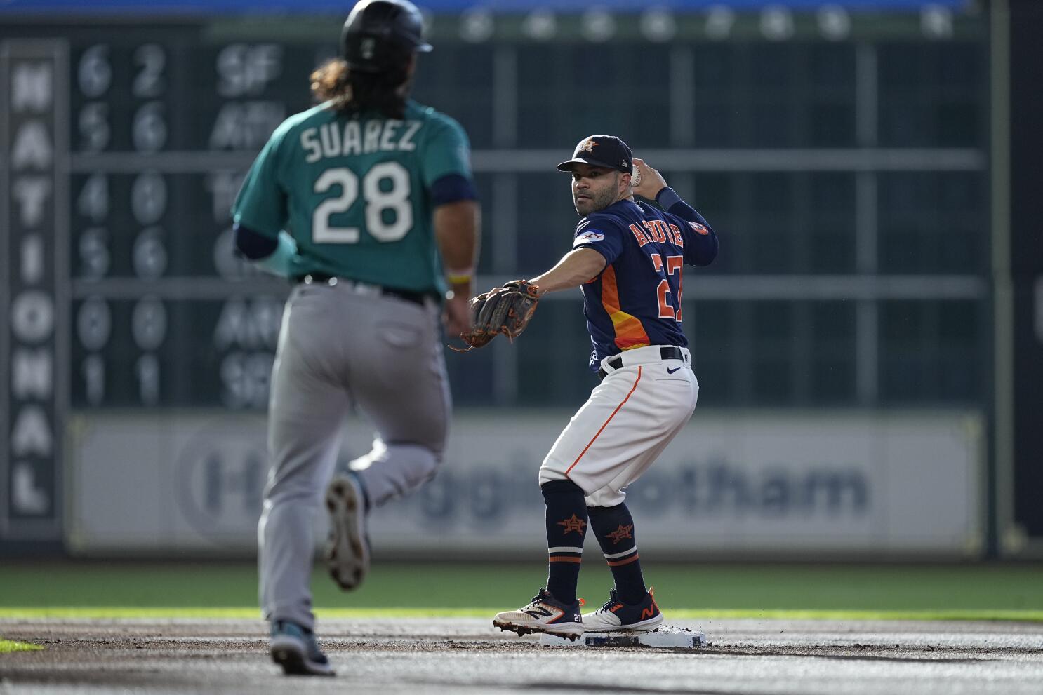 Seattle Mariners' Nelson Cruz tips his batting helmet to the crowd from the  dugout after he hit a three-run home run during the eighth inning of the  team's baseball game against the