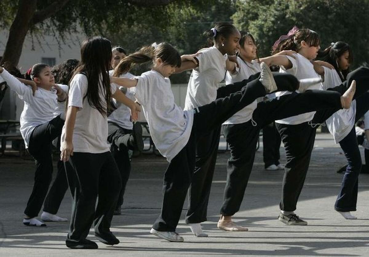 Students dance in a gym class.