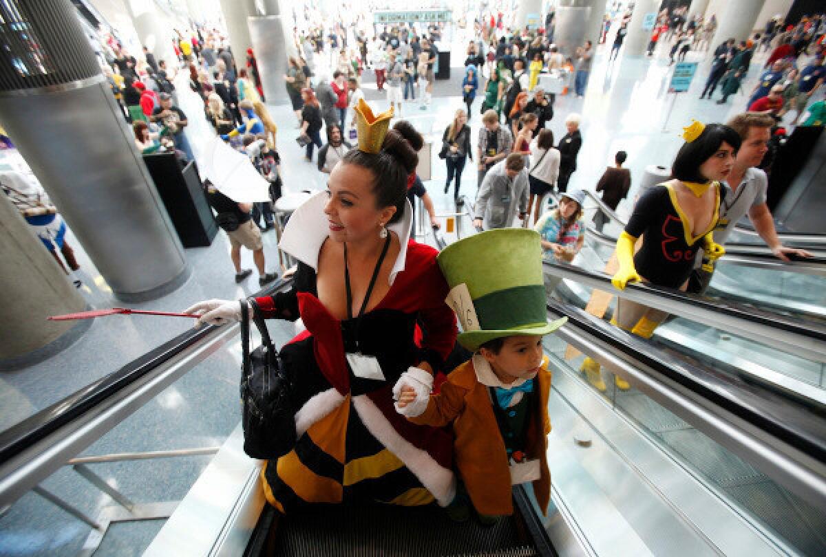 Cosplayers ride escalators in the L.A. Convention Center 