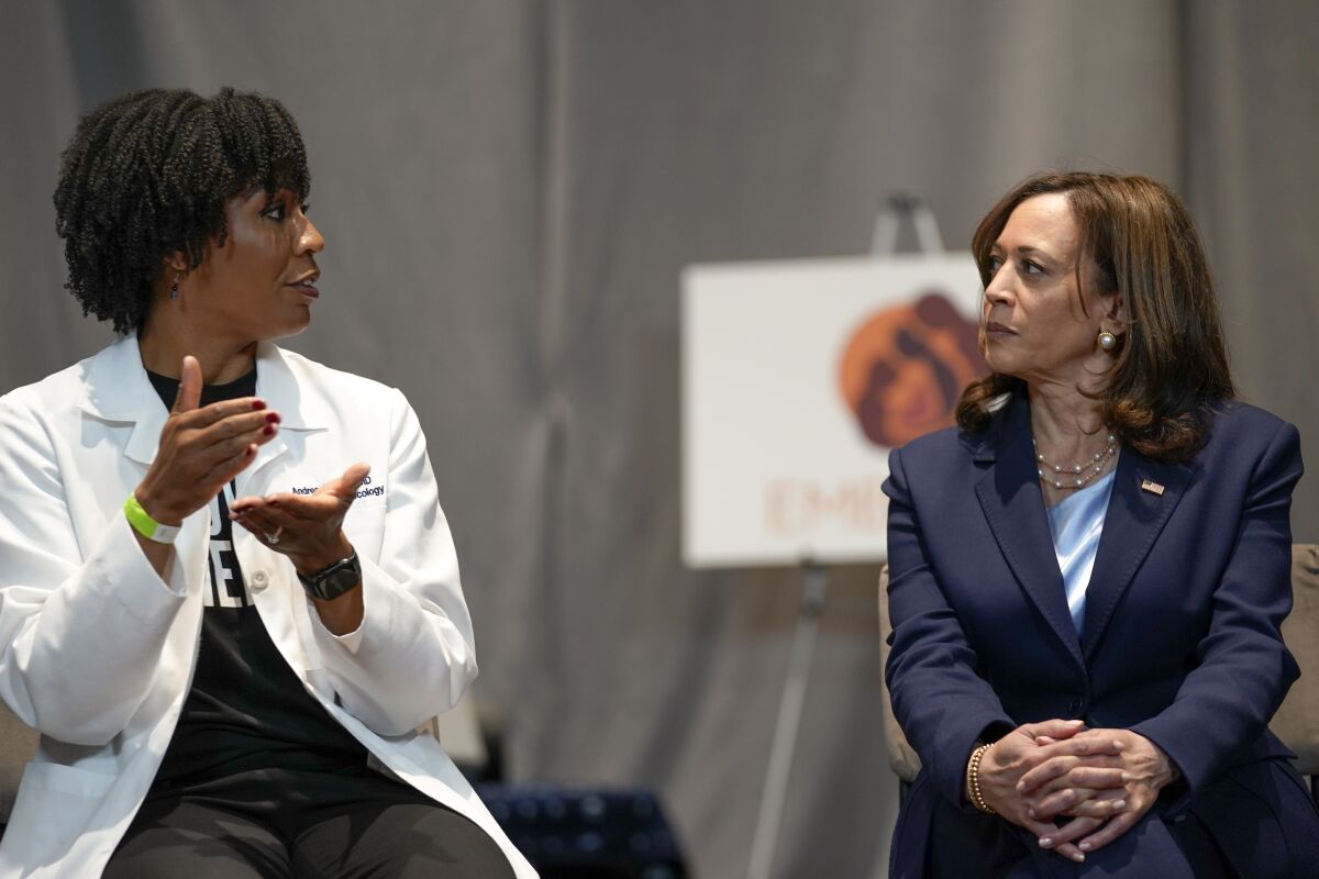 Vice President Kamala Harris, right, listens to Dr. Andrea Jackson.