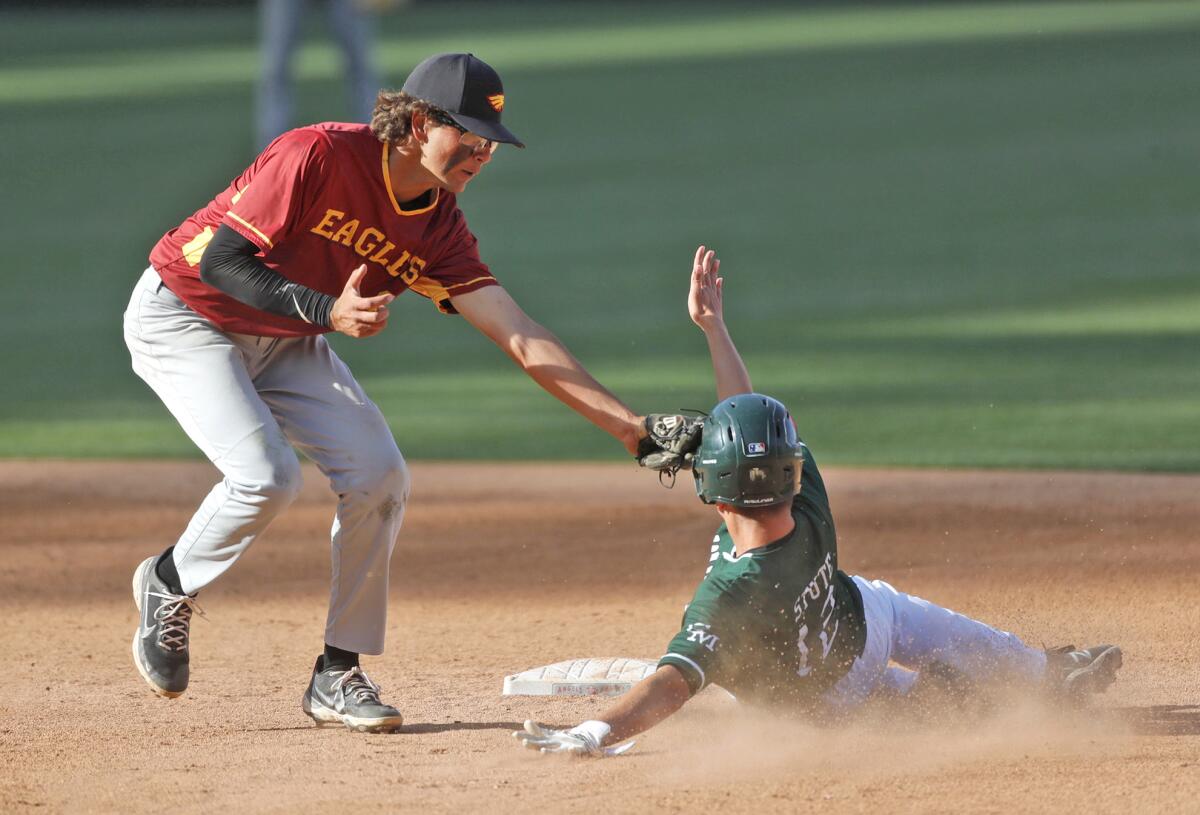 Estancia's Jack Moyer, left, tags out Costa Mesa's Sam Stute during Monday's Halo Classic game at Angel Stadium.