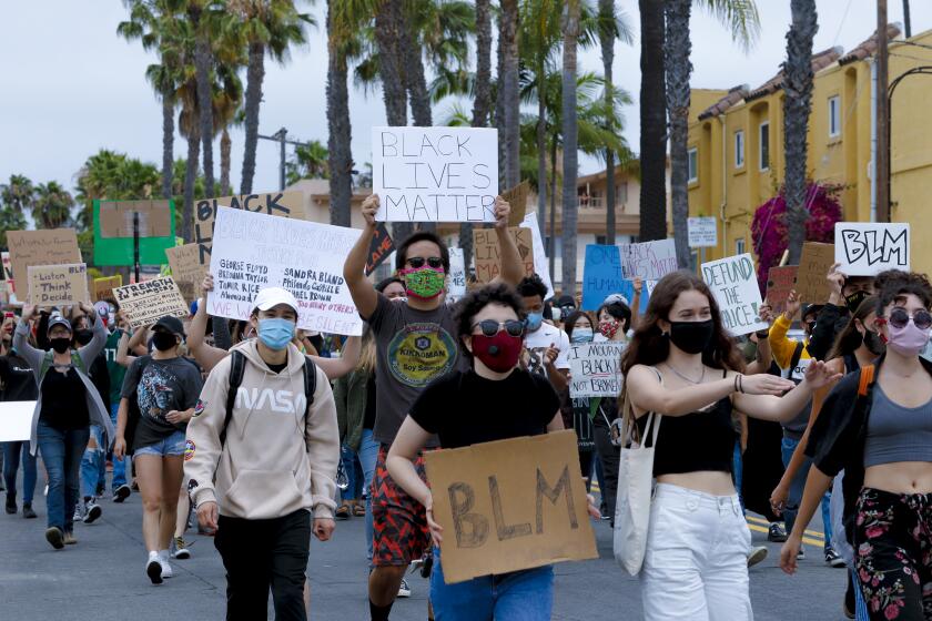 An estimated 400 protestors marched down Garnet Avenue in Pacific Beach on Wednesday showing support for Black Lives Matter. 
