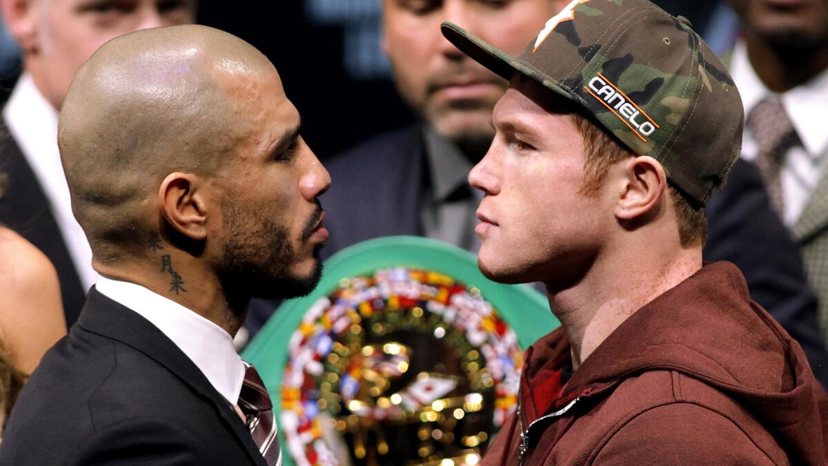Miguel Cotto, left and Saul 'Canelo' Alvarez face off during their news conference on Wednesday in Las Vegas.
