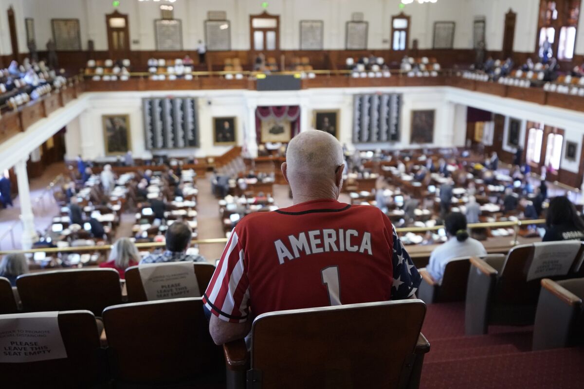 A man sits in the House chamber at the Texas Capitol.