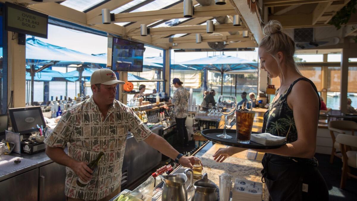 Employees work the lunch shift at the Wind and Sea restaurant. Over the years, some employees have met, married, and their kids have worked at the restaurant, says owner Robert Mardian.