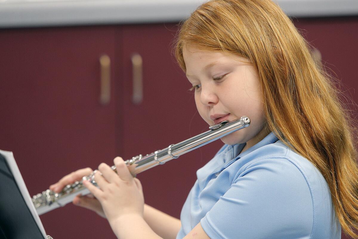 Music student Elisa Barrig, of the Caesura Youth Orchestra, plays the flute at rehearsal at Cerritos Elementary School in Glendale on Tuesday. A fundraiser for the music program will be held at a performance called "A Portrait of Fall" at the Glendale City Church on Sunday at 4 p.m.