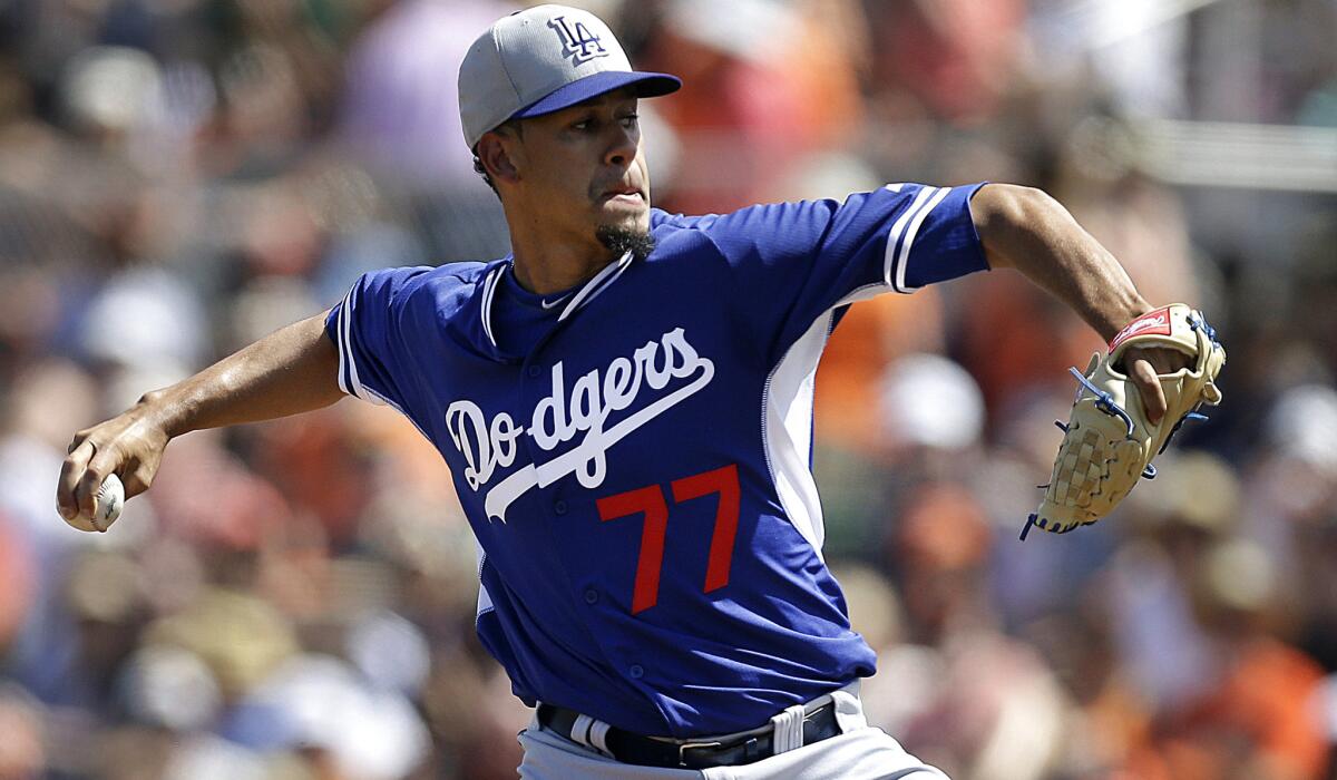 Dodgers pitcher Carlos Frias delivers in the first inning against the Giants on Sunday.