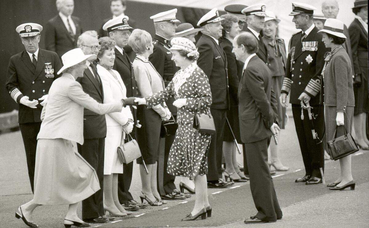 Mrs. George Finlayson, wife of the British Consul General, curtsies before Queen Elizabeth II  in reception line