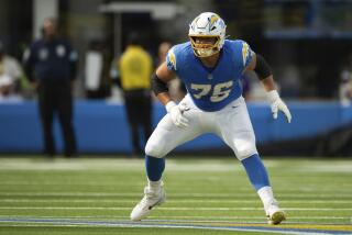 Chargers rookie offensive tackle Joe Alt readies to pass block.