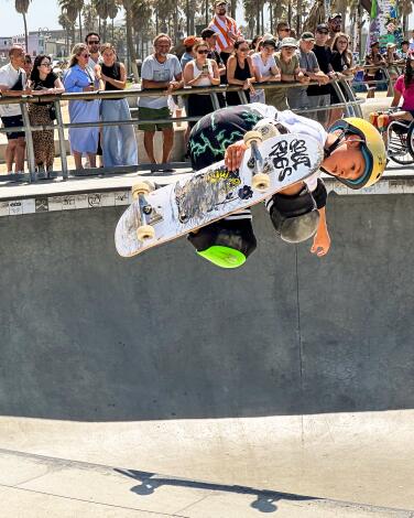 A skateboarder flies out of the bowl at Venice Beach Skate Park