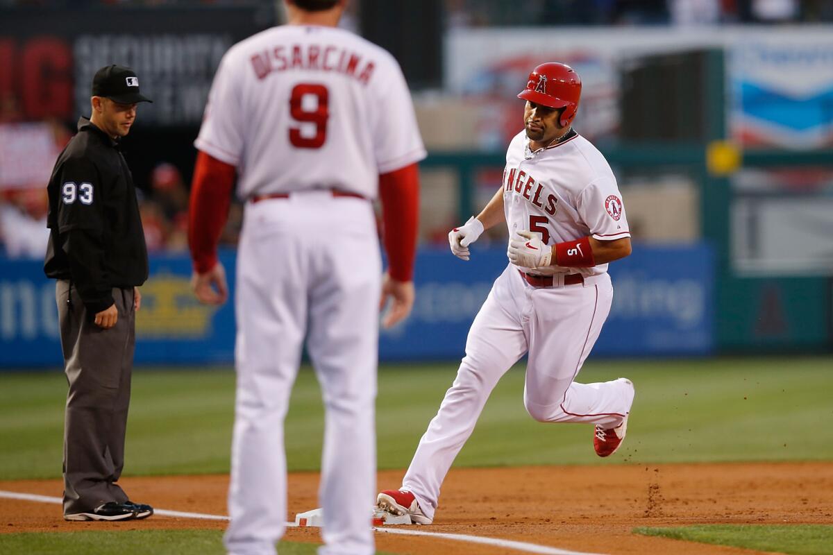 Albert Pujols rounds third base after hitting a three-run home run in the second inning Saturday against Detroit at Angel Stadium.