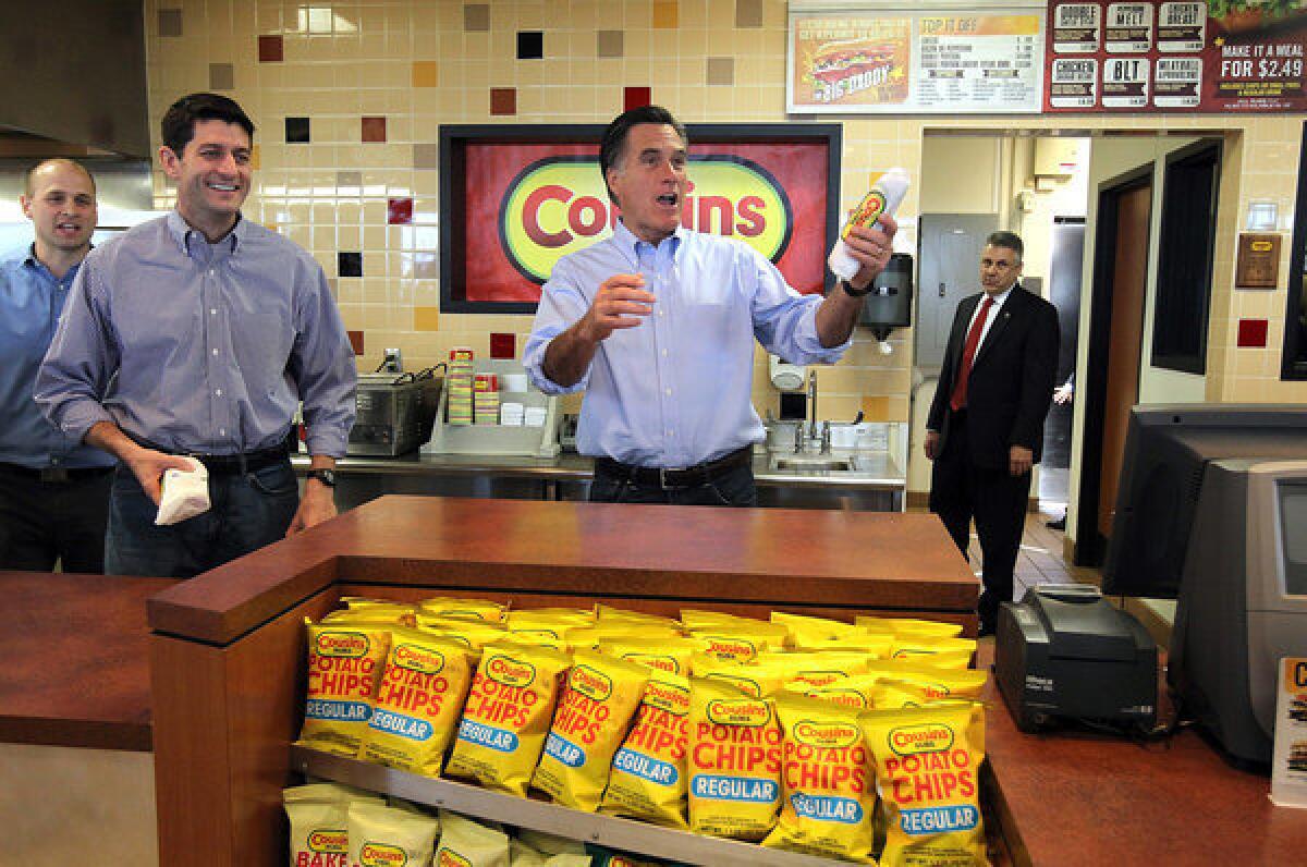 U.S. Rep. Paul D. Ryan (R-Wis.), left, and Republican presidential candidate Mitt Romney hand out sandwiches to supporters at Cousins Subs in Waukesha, Wis.
