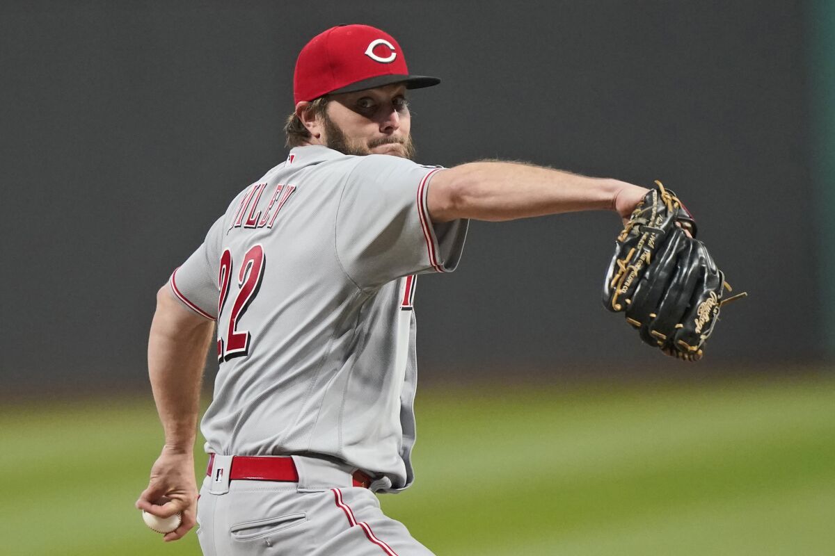 Cincinnati Reds starting pitcher Wade Miley delivers in the first inning of a baseball game against the Cleveland Indians, Friday, May 7, 2021, in Cleveland. (AP Photo/Tony Dejak)