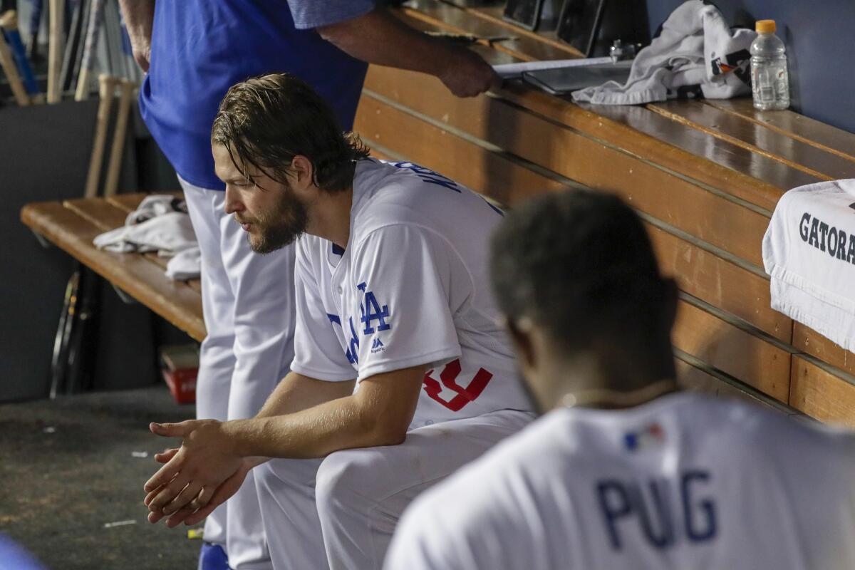 Dodgers starting pitcher Clayton Kershaw rests in the dugout after completing seven innings.