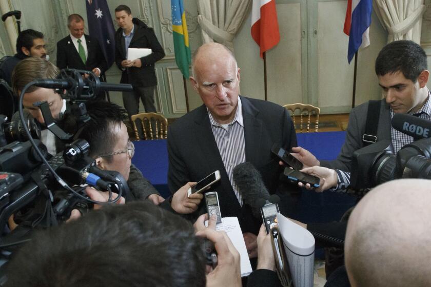 Gov. Jerry Brown speaks to the media after a signing ceremony at the COP 21, the U.N. climate change conference in Paris.