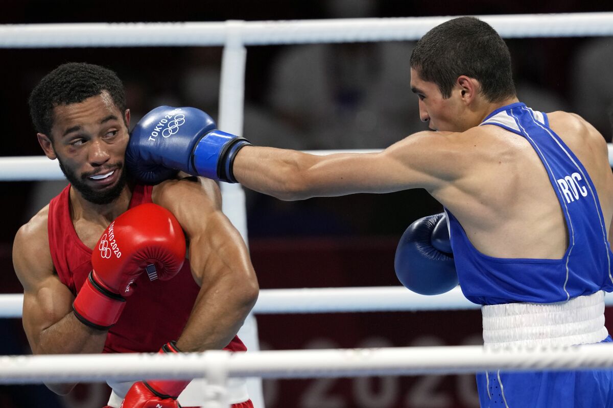 Duke Ragan, of the United States, left, takes a shot from Albert Batyrgaziev, of the Russian Olympic Committee, during their final feather weight 52-57kg final boxing match at the 2020 Summer Olympics, Thursday, Aug. 5, 2021, in Tokyo, Japan. (AP Photo/Themba Hadebe)