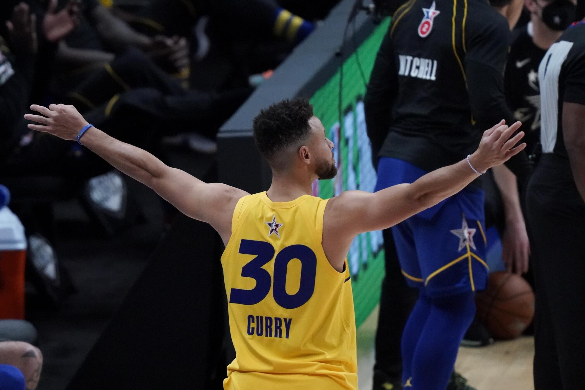 Warriors guard Stephen Curry celebrates during the three-point contest.