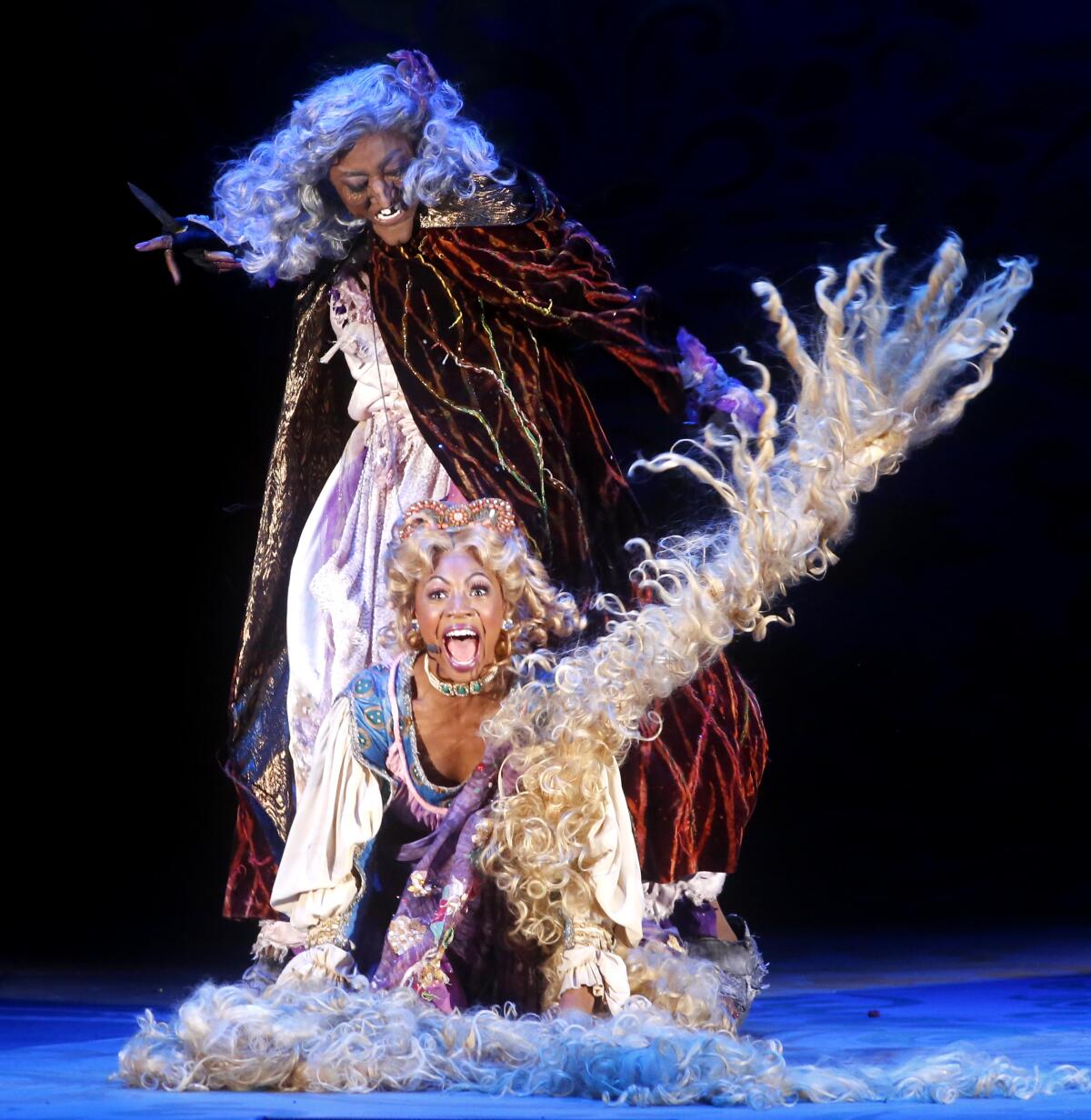 Patina Miller, background, as the Witch, and Hailey Kilgore, as Rapunzel, perform in Stephen Sondheim's musical, "Into the Woods," at the Hollywood Bowl on Friday.