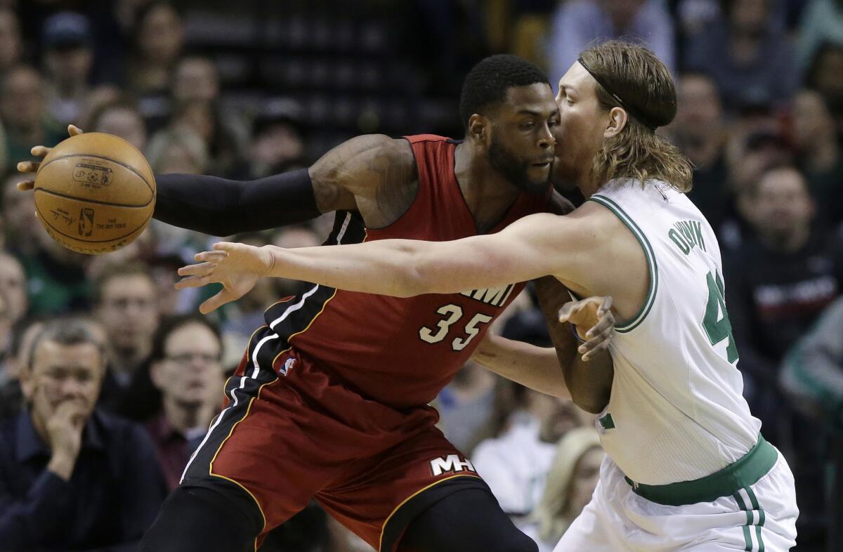 Then-Miami Heat center Willie Reed tries to drive past Boston Celtics center Kelly Olynyk during a game on March 26 in Boston.