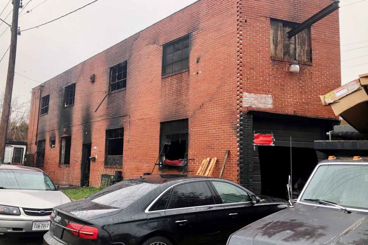 A burned-out warehouse is seen, Tuesday, Dec. 6, 2022, in Baltimore. A man was found dead inside the building Sunday morning, hours after firefighters extinguished the blaze. (AP Photo/Lea Skene)