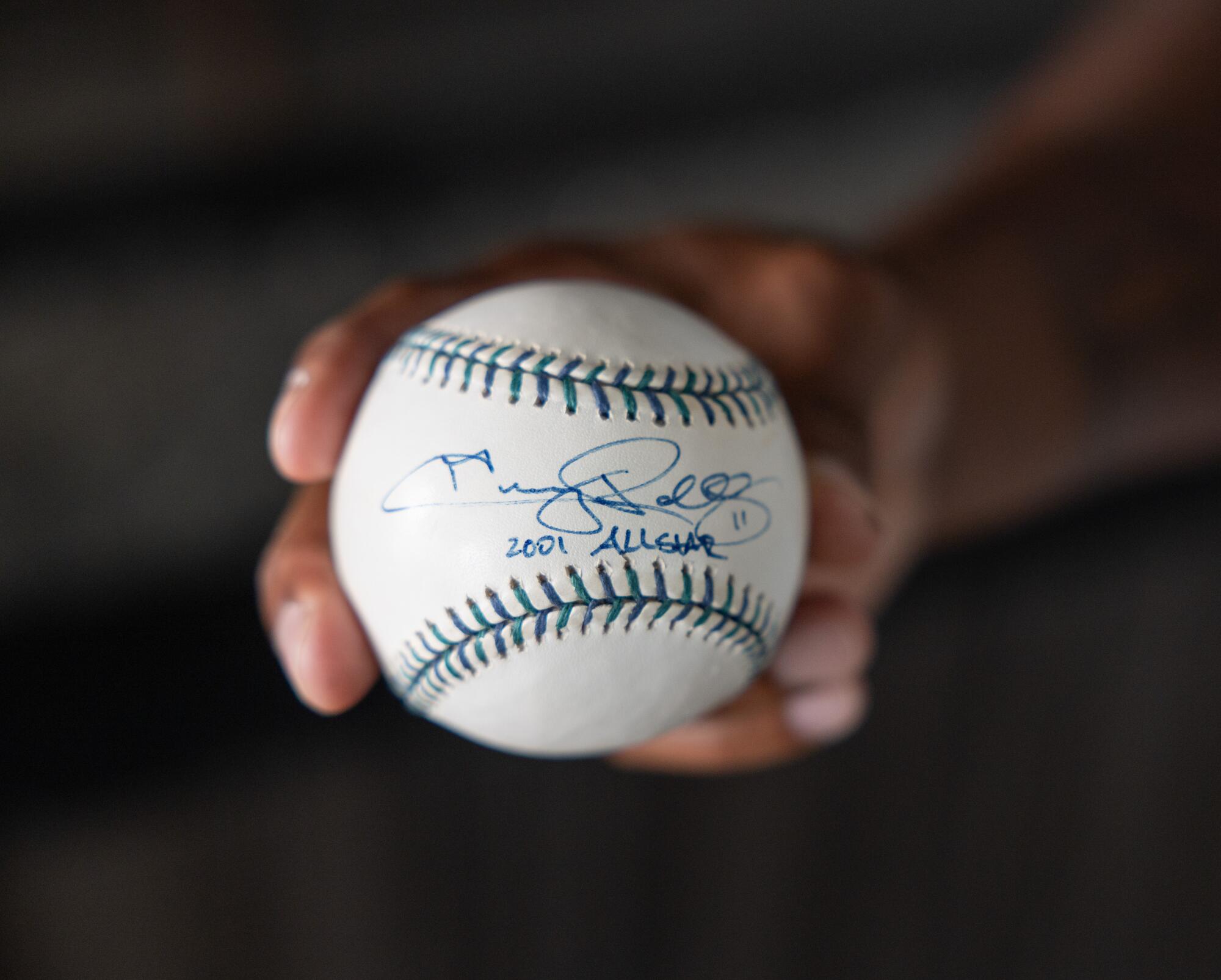 Jimmy Rollins shows off a baseball he had autographed during the 2001 MLB All-Star Game. 