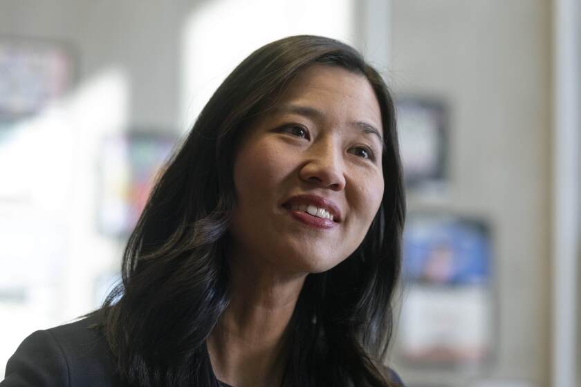 Boston Mayor Michelle Wu speaks with a reporter in her office at City Hall, Wednesday, March 30, 2022, in Boston. (AP Photo/Michael Dwyer)