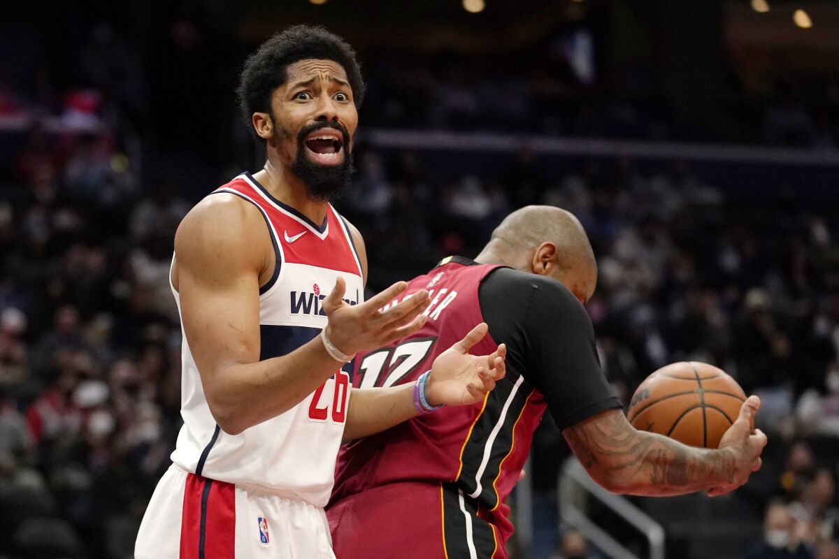 Washington Wizards guard Spencer Dinwiddie argues a foul call on Miami Heat forward P.J. Tucker, right, during the first half of an NBA basketball game, Monday, Feb. 7, 2022, in Washington. (AP Photo/Evan Vucci)