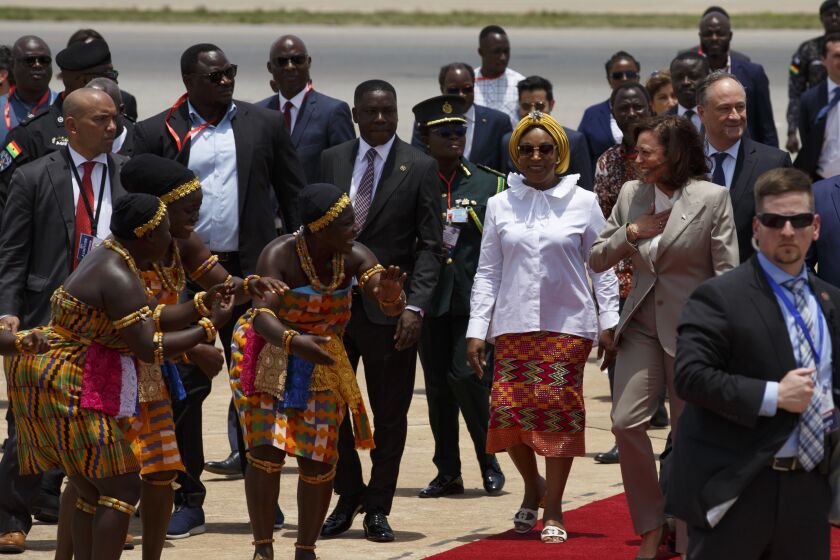 U.S. Vice President Kamala Harris is greeted by traditional dancers as she arrives in Accra, Ghana, Sunday March 26, 2023. Harris is on a seven-day African visit that will also take her to Tanzania and Zambia. (AP Photo/Misper Apawu)
