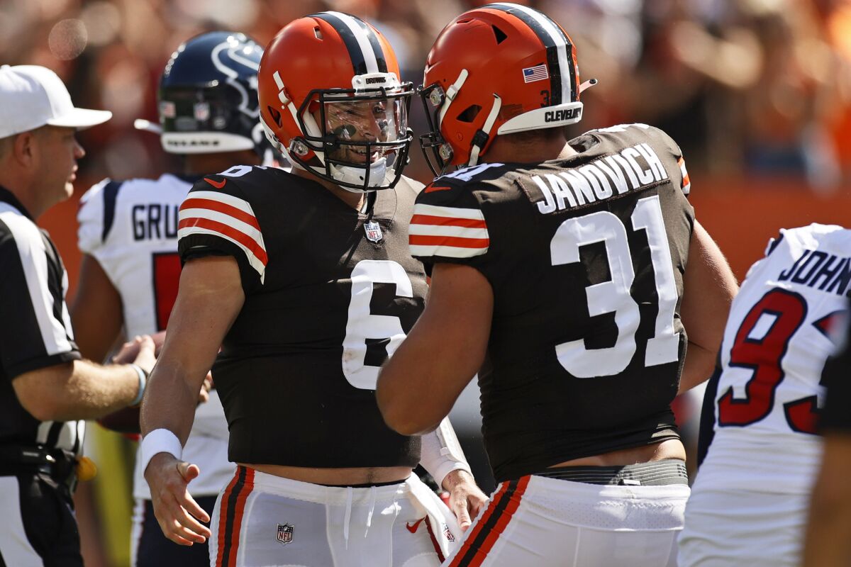 Cleveland Browns quarterback Baker Mayfield, left, celebrates with Andy Janovich after Janovich scored a 1-yard touchdown during the first half of an NFL football game against the Houston Texans, Sunday, Sept. 19, 2021, in Cleveland. (AP Photo/Ron Schwane)