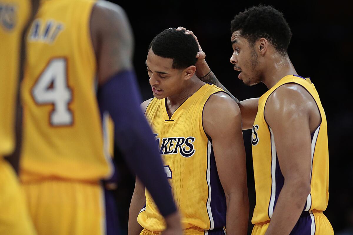 Lakers teammates D'Angelo Russell, right, and Jordan Clarkson share a moment of support during a break in the action against the Sacramento Kings on Jan. 20.