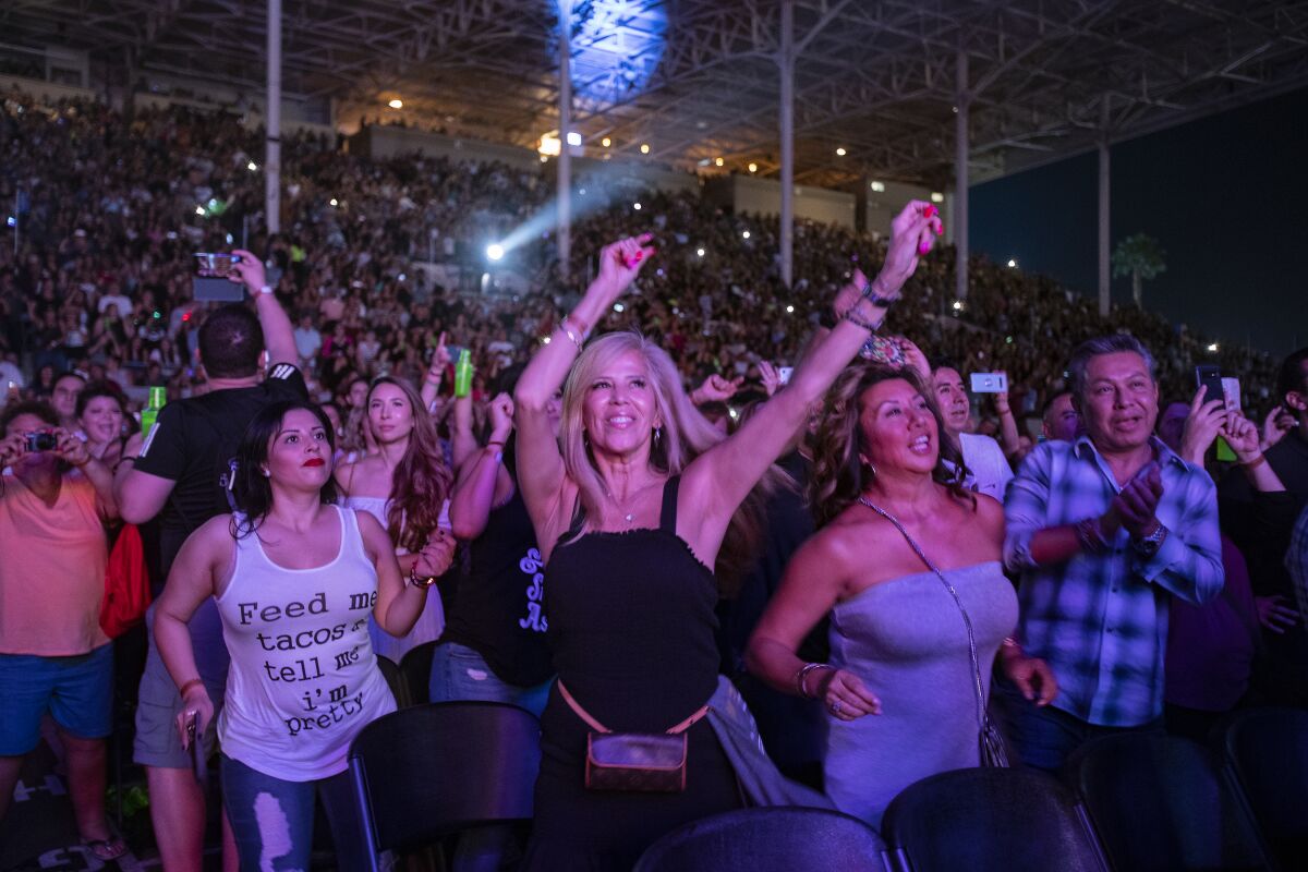 Fans dance as Pitbull performs at the L.A. County Fair in Pomona.